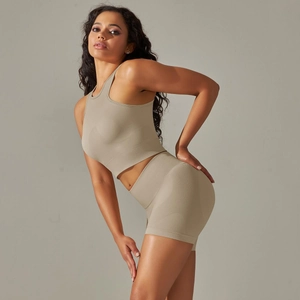Detail view of khaki seamless ribbed knit fabric on women's sports crop top and shorts set