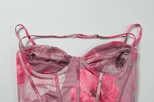 Detail of pink floral corset top with boning structure and ruched bust design