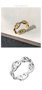 Macro shot of 18k gold and silver interlocking link rings in minimalist style