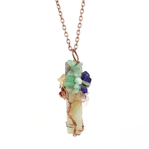 Detailed view of handmade copper tree of life pendant with colorful natural gemstones