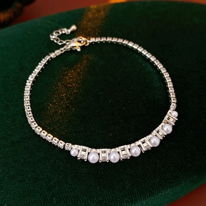 Detail of silver chain bracelet with white pearls and sparkling cubic zirconia stones