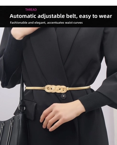 Close-up of golden elastic metal waist chain with elegant woven knot buckle on black blazer