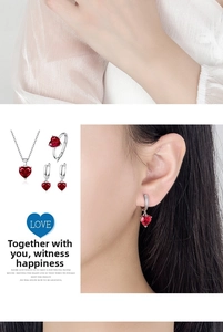 Detailed set of silver necklaces rings and earrings with red heart shaped zircon gems