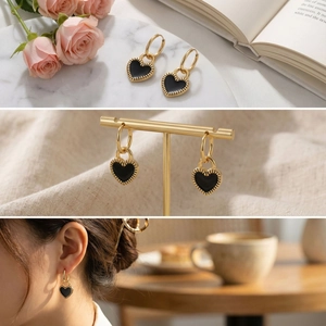 Detail view of gold hoop earrings with black heart charms and floral lifestyle scenes