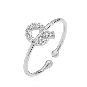 Macro view of adjustable silver letter F ring with cubic zirconia stones on white background