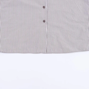 Detail showing vertical black and white stripes fabric and button closure of the shirt