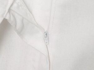 Detailed macro view of the matching white zipper closure on the bomber jacket set