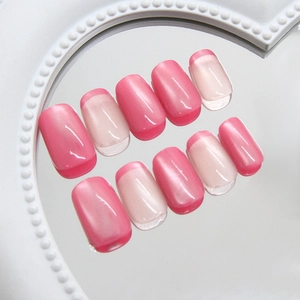 Pink cat eye press-on nails in oval shape with French tip style on heart mirror