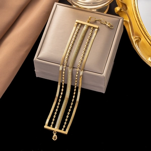 Multilayer gold stainless steel chain bracelet with snake and bead design on jewelry box