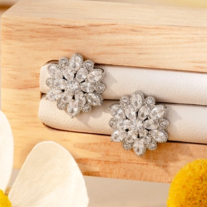 Sparkling silver flower stud earrings with marquise zircon stones on a premium display