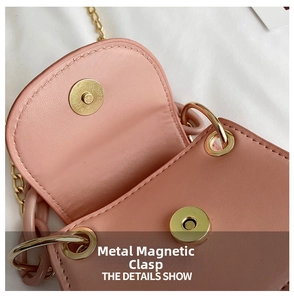 Close-up of golden magnetic buckle and textured pink faux leather on mini jelly bag
