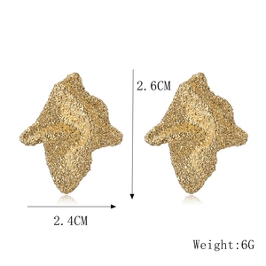 Detail of gold metal earrings showing size 2.6x2.4cm and textured teardrop surface