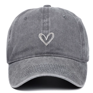 Detailed view of grey washed cotton baseball cap with white heart embroidery design
