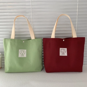 Green and maroon canvas tote bags with cute cartoon dog pattern and lovable text