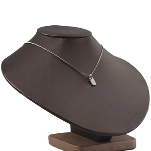 Detailed view of a silver stainless steel rectangular pendant on a sleek bead chain