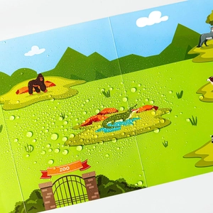 Detail showing waterproof surface of zoo animal sticker book with water droplets