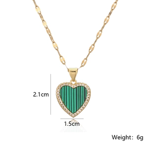 Detail of 18K gold heart pendant with green gemstone and dimensions 2.1cm by 1.5cm