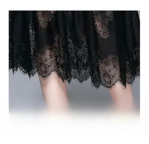 Detail of elegant black floral lace hemline with eyelash fringe and sheer texture