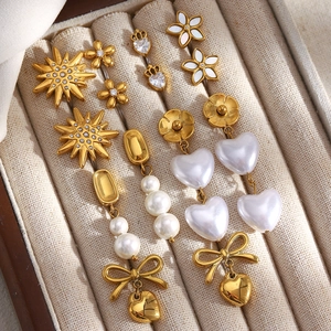 Detailed collection of 18K gold plated earrings with pearls, zircon flowers and star motifs