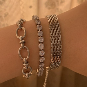 Close-up of three-piece silver-toned stainless steel bracelet set with pavé zircon