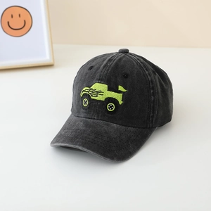 Close-up of bright green truck embroidery on washed denim kids baseball cap