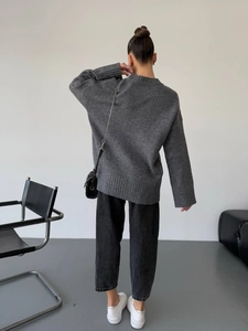 Rear view of deep gray oversize knit sweater showing loose fit and soft texture