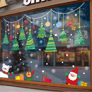 Christmas window stickers with Santa Claus reindeer and snowflakes on a glass storefront