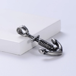 Vintage stainless steel nautical anchor pendant with rope detail on stone display