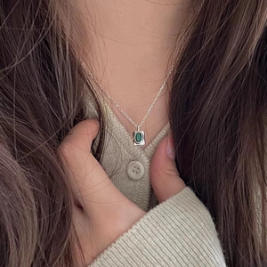Elegant 925 sterling silver necklace featuring an oval green zircon gemstone pendant on model