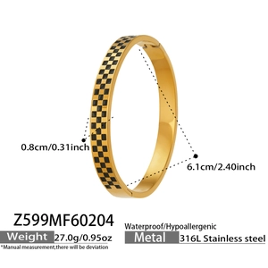 Detailed macro view of gold-plated stainless steel bangle with yellow and black checkerboard