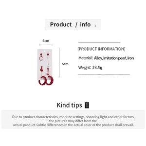 Detail view of red bow knot and pearl earring dimensions with specifications text