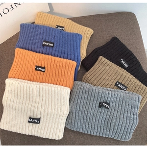 Multi-color knitted headbands with ribbed texture and brand label in flat lay display