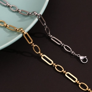 Detail of 14K gold and silver stainless steel paperclip link anklet with lobster clasp