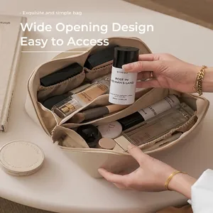 Cream large capacity leather cosmetic bag with wide-open design for travel storage