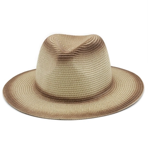 Close-up of fine straw texture and brown gradient dye on the jazz fedora hat