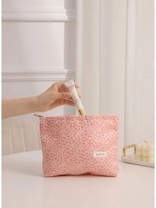 Pink leopard print cosmetic bag with textured fabric and spacious interior for travel