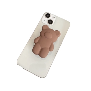 3D brown bear pop-out phone stand holder on a smartphone with a matte silicone texture