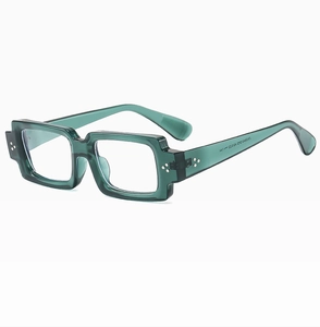 Detail view of deep green transparent square frames with metallic rivet hardware on temples