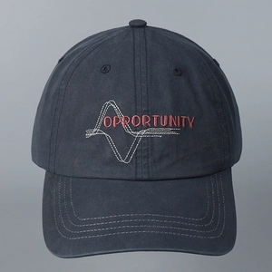 Detail of red OPPORTUNITY embroidery on a washed cotton navy blue baseball cap