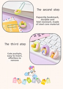 Detail of macaron stationery set featuring resin donut and rainbow paper clips on a desk
