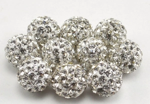 Macro shot of 10mm white Shamballa clay beads with crystal rhinestones for DIY jewelry