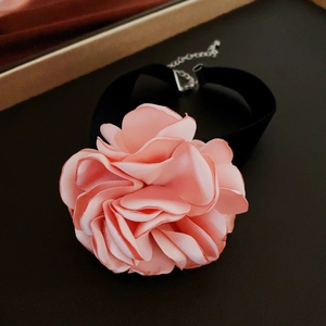 Detail of the pink flocked rose floral choker necklace with silver chain adjustment