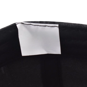 Detailed view of the 100% cotton material label and wash care icons inside the cap
