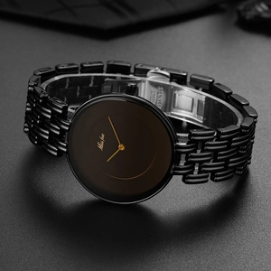 Detailed macro view of black stainless steel watch links and branded folding clasp closure