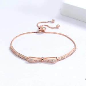 Macro detail of rose gold bow bracelet with cubic zirconia and adjustable bolo clasp