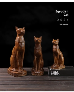Three sizes of Egyptian cat statues with wood texture on a dark wooden surface