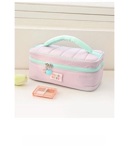 Close-up of quilted lavender cosmetic bag featuring mint green zipper and heart charm