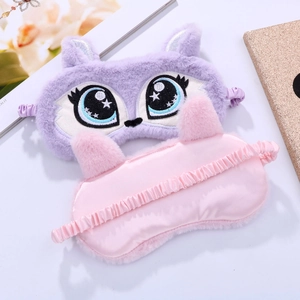 Detailed plush eye mask showing cute embroidered cartoon eyes and elastic satin strap