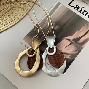 Elegant gold and silver tone snake chain necklace with woven leather water drop pendant