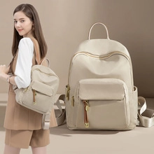Beige nylon backpack with golden hardware shown as lifestyle and still detail views